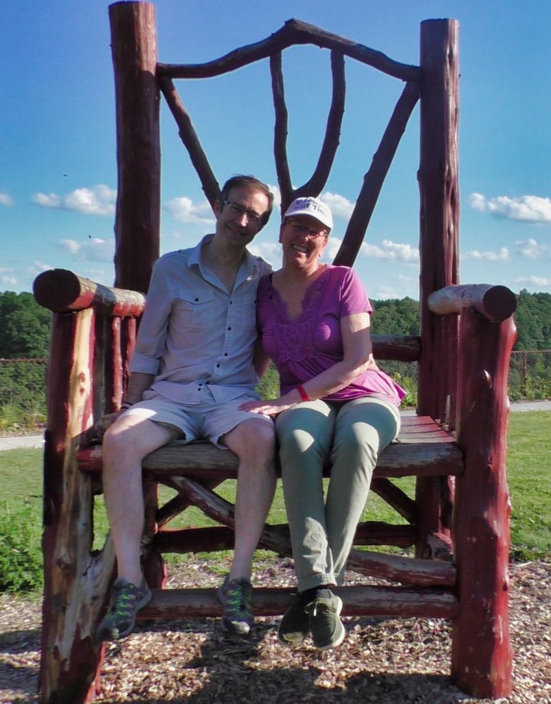 Mitch and Dina sitting on over-sized chair in Letchworth State Park Waterfall, New York, USA
